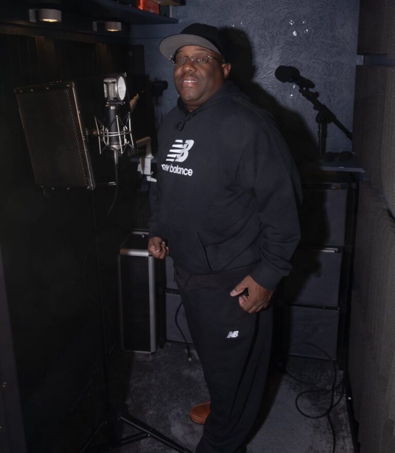 Artist standing at the microphone in the vocal booth