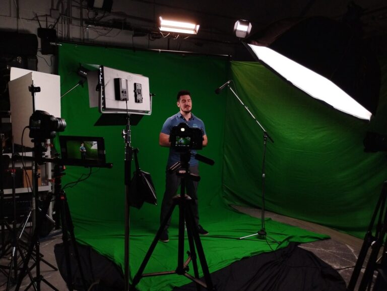 Presenter filmed on green screen with camera and softbox lighting