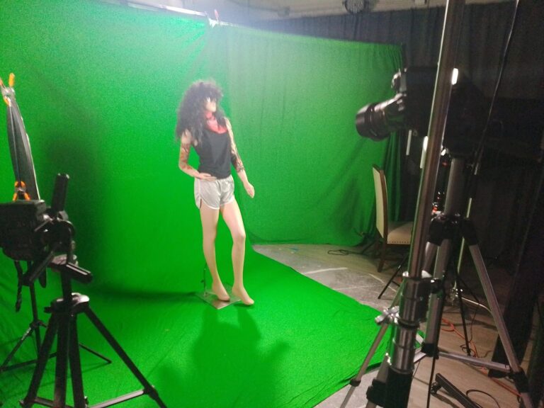 Performer on the green screen stage under studio lights