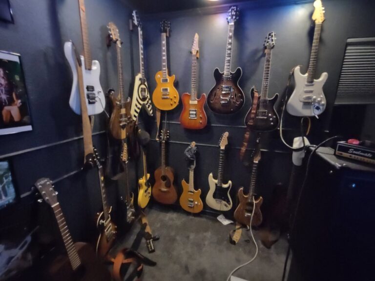 Wall of electric and acoustic guitars in the studio