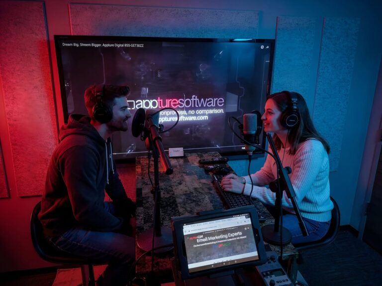 Two hosts recording a podcast on the interview set