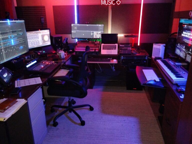 Recording control room with mixing desk, monitors and keyboards