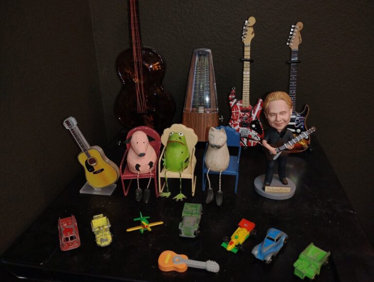 Guitars and collectible props arranged on a studio set